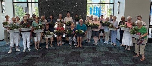Volunteers holding flower planters